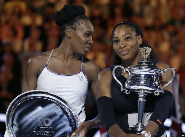 Venus and Serena Williams with their trophies