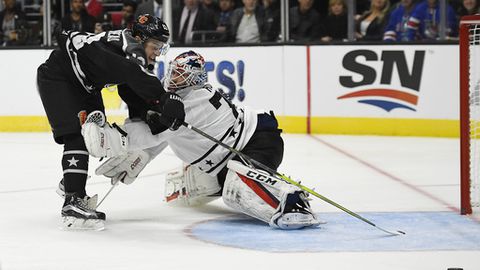 Pacific Division forward Johnny Gaudreau left of the Calgary Flames tries to get a shot past Metropolitan Division goalie Braden Holtby of the Washington Capitals during an NHL All Star hockey game at Staples Center Sunday Jan. 29 2017 in Los Ang