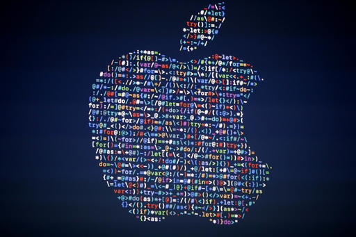 The Apple logo is shown on a screen at the Apple Worldwide Developers Conference in the Bill Graham Civic Auditorium in San Francisco. Google Apple and other tech giants expressed dismay over an executive order