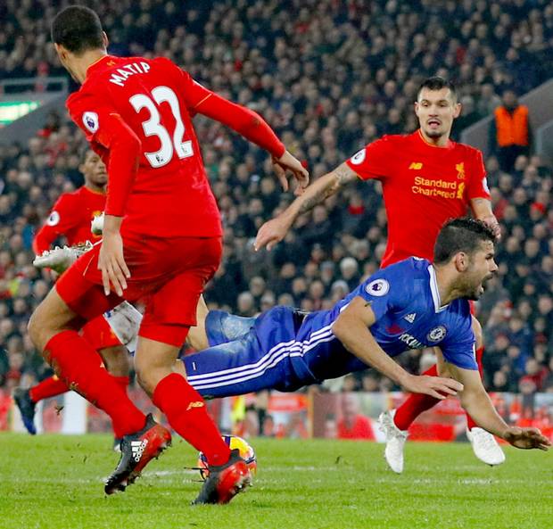 Chelsea’s Diego Costa goes to ground after clashing with Joel Matip resulting
in a penalty at Anfield last night