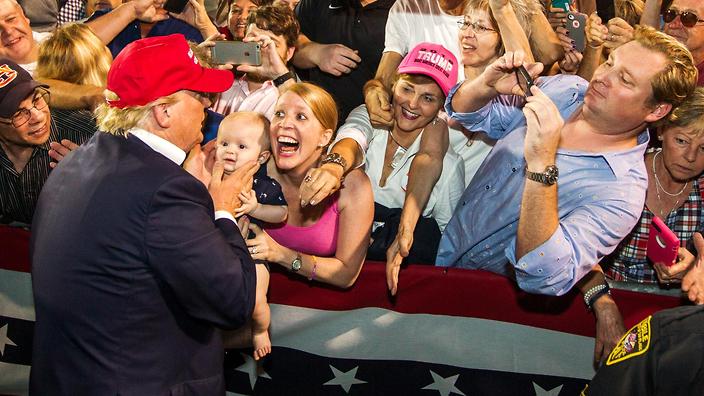 Donald Trump greets supporters after his rally at Ladd Peebles Stadium