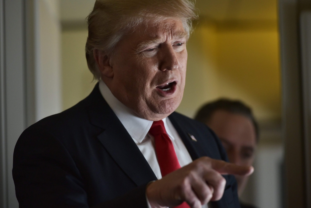 3 2017 shows US President Donald Trump speaking with reporters on board Air Force One before departing from Andrews Air Force Base in Maryland bound for Palm Beach Florida. Trump has rebuffed calls for a toughe