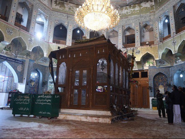 Pakistani devotees stand on the blood-stained floor a day after a bomb attack hit the 13th century Muslim Sufi shrine of Lal Shahbaz Qalandar in the town of Sehwan in Sindh province some 200 kilometres northeast of the provincial capital Karachi on Febr