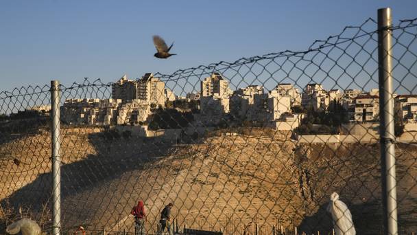 Palestinian labourers work at a new housing project in the Israeli settlement of Maale Adumim near Jerusalem