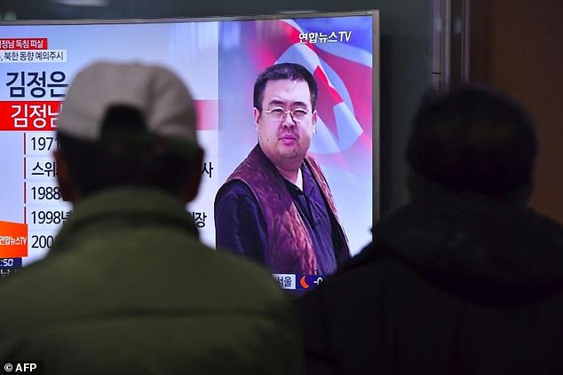 People in a Seoul railway station watch a television news report on the death of Kim Jong-Nam the half-brother of North Korean leader Kim Jong-Un