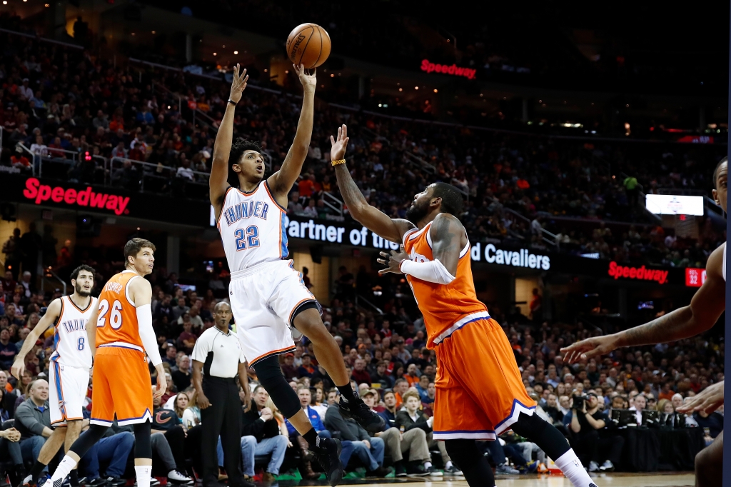 Cameron Payne #22 of the Oklahoma City Thunder shoots over Kyrie Irving #2 of the Cleveland Cavaliers during the first half at Quicken Loans Arena