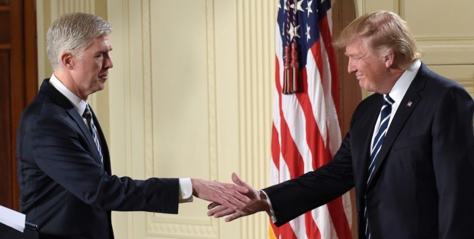 10th U.S. Circuit Court of Appeals Judge Neil Gorsuch reaches to shake hands with President Donald Trump after his announcement as President Trump's choice for Supreme Court Justice during a televised address from the East Room of the White House