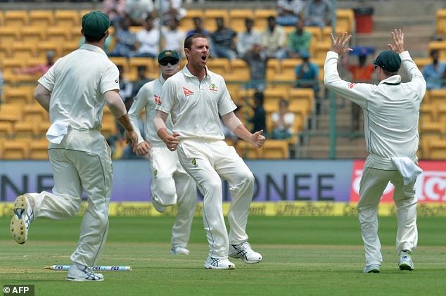 Australia fast bowler Josh Hazlewood celebrates the dismissal of India batsman Abhinav Mukund with his teammates on the third day of the second Test at The M. Chinnaswamy Stadium in Bangalore