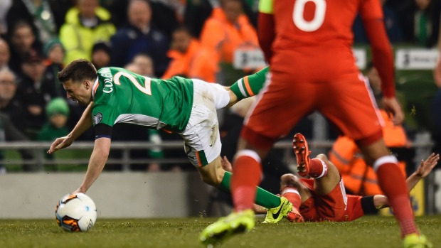 Ireland's Seamus Coleman goes down after a nasty challenge by Neil Taylor of Wales