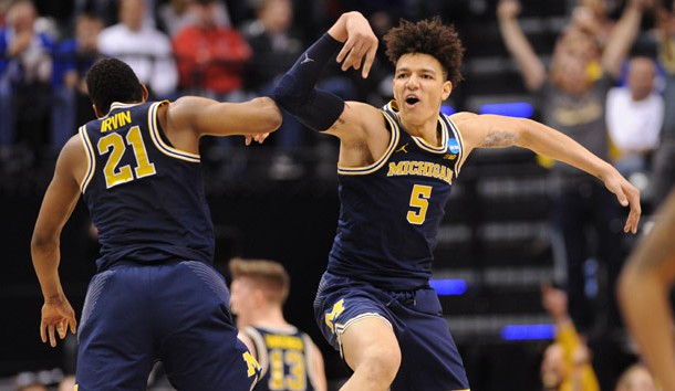 Mar 19 2017 Indianapolis IN USA Michigan Wolverines guard Zak Irvin celebrates with forward D.J. Wilson after defeating the Louisville Cardinals in the second round of the 2017 NCAA Tournament at Bankers Life Fieldhouse