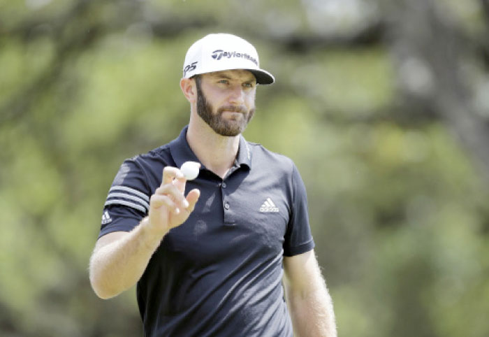 Dustin Johnson waves to the after making a putt on the sixth hole at the Dell Technologies Match Play Golf Tournament at Austin County Club in Austin Wednesday. — AP