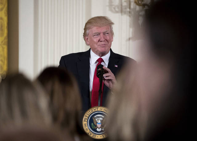 ASSOCIATED PRESS           President Donald Trump paused Wednesday while speaking in the East Room of the White House in Washington. A new survey shows most Americans disapprove of Trump’s performance but they’re more upbeat