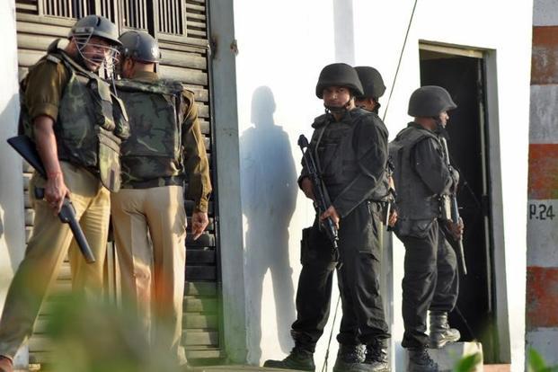 UP Anti Terrorist Squad commandos local police stand guard outside a house where a suspected militant was hiding in Thakurganj area of Lucknow on 7 March 2017