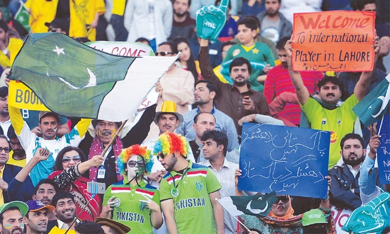 LAHORE Spectators in a festive mood before the start of the PSL final at Gaddafi Stadium.—AFP