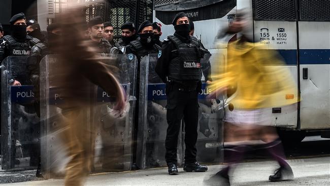 Turkish anti-riot police officers stand guard the street in front of the Netherlands consulate as they demonstrate