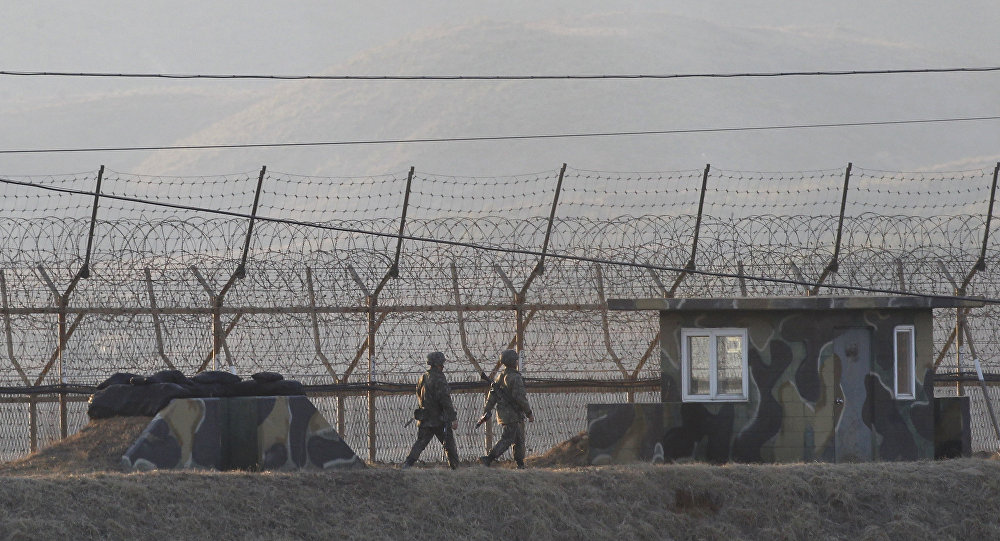 South Korean army soldiers patrol along the barbed-wire fence in Paju South Korea near the border with North Korea Monday