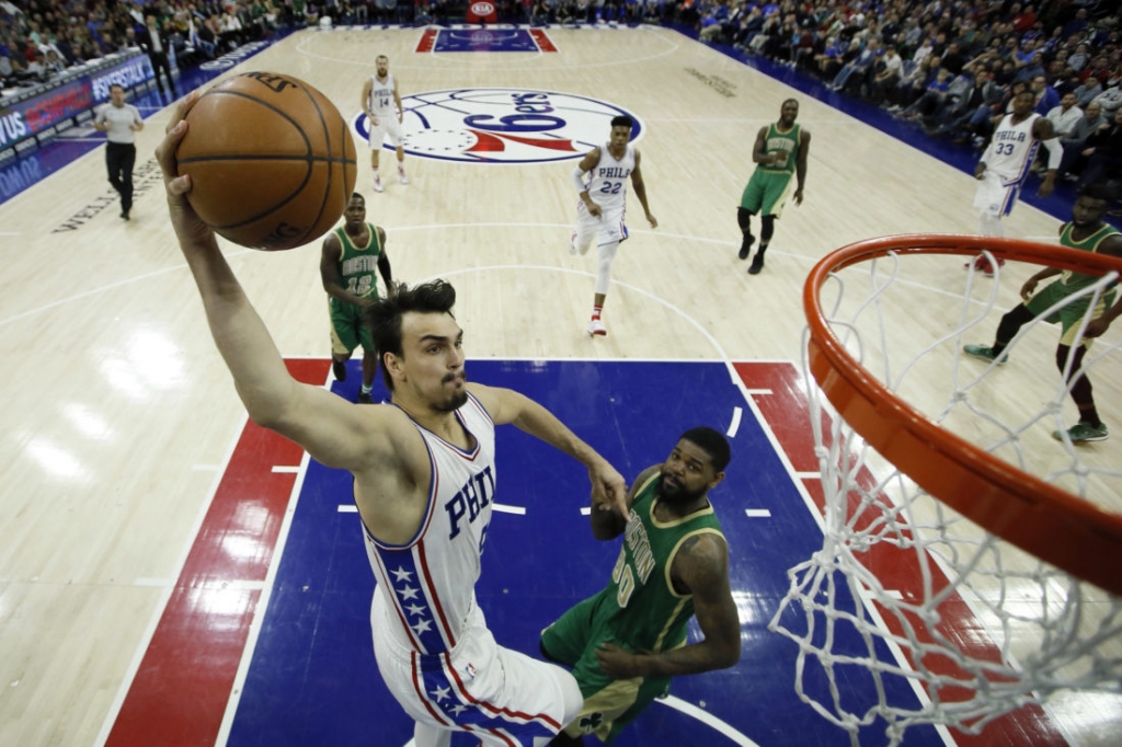 Philadelphia 76ers&#039 Dario Saric left goes up for a shot against Boston Celtics&#039 Amir Johnson during the second half of an NBA basketball game Sunday