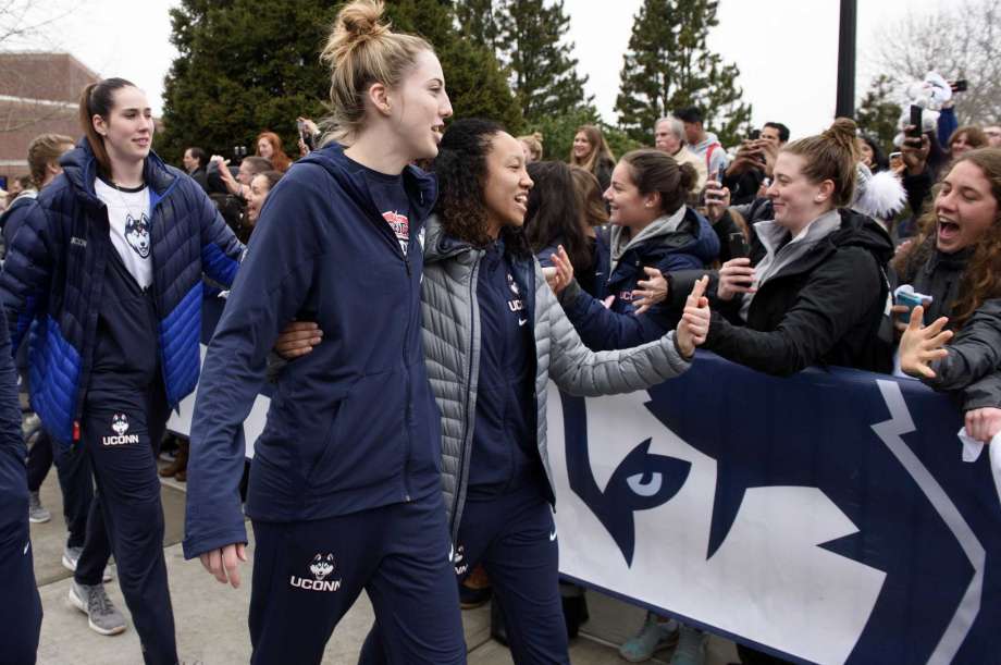 Connecticut basketball players Katie Lou Samuelson front left and Saniya Chong greet fans outside Gampel Pavilion in Storrs Conn. Tuesday