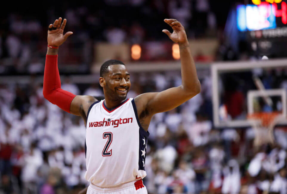 Washington Wizards guard John Wall reacts to the cheering Wizards fans during the second half in Game 1 of a first-round NBA basketball playoff series in Washington Sunday