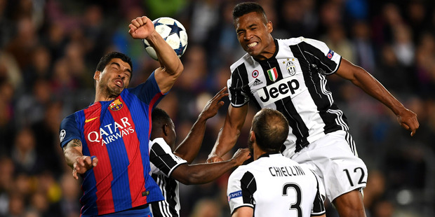 Barcelona's Luis Suarez and Juventus Alex Sandro contest for the ball during their side's Champions League semi-final second leg clash at the Nou Camp in Barcelona this morning