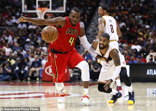 Atlanta Hawks forward Paul Millsap and Cleveland Cavaliers guard Kyrie Irving fight for the ball in the second half of an NBA basketball game on Sunday