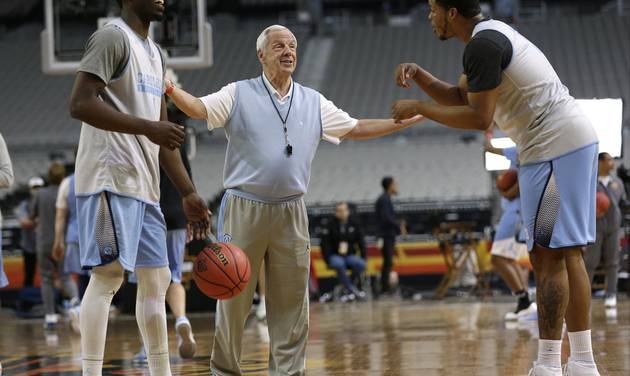 North Carolina head coach Roy Williams center laughs with forward Theo Pinson left and forward Kennedy Meeks right during a practice session for their NCAA Final Four tournament college basketball semifinal game Friday