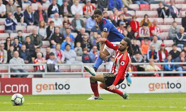 Marcus Rashford scores Manchester United's third goal against Sunderland during their EPL match at the Stadium of Light in Sunderland yesterday