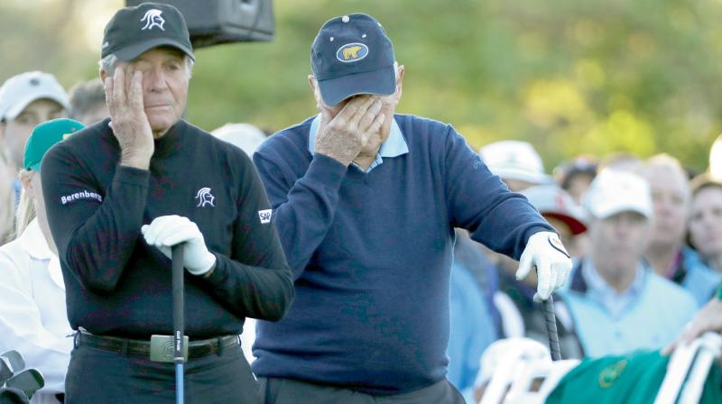 Jack Nicklaus and Gary Player get emotional as a chair is draped with a green jacket to honour Arnold Palmer before the ceremonial tee-off of the Masters golf tournament in Augusta