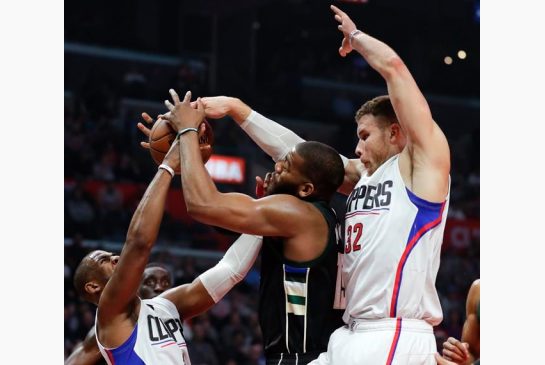 Milwaukee Bucks center Greg Monroe center vies for a rebound with Los Angeles Clippers guard Chris Paul left and forward Blake Griffin during the first half of an NBA basketball game in Los Angeles. The Clip