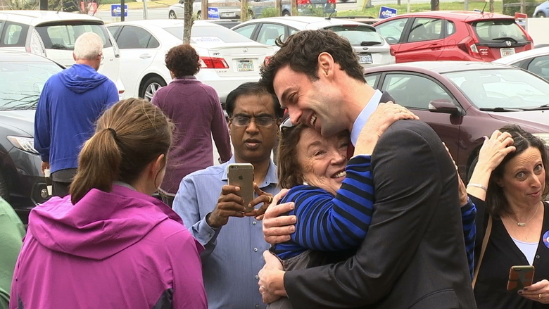 Democratic Congressional candidate Jon Ossoff greets supporters outside of the East Roswell Branch Library in Roswell Ga. on the first day of early voting. President Donald Trump is attacking the leading Democratic can