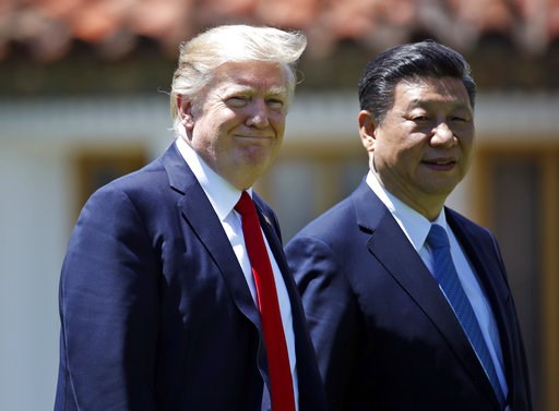 President Donald Trump and Chinese President Xi Jinping walk together after their meetings at Mar-a-Lago Friday