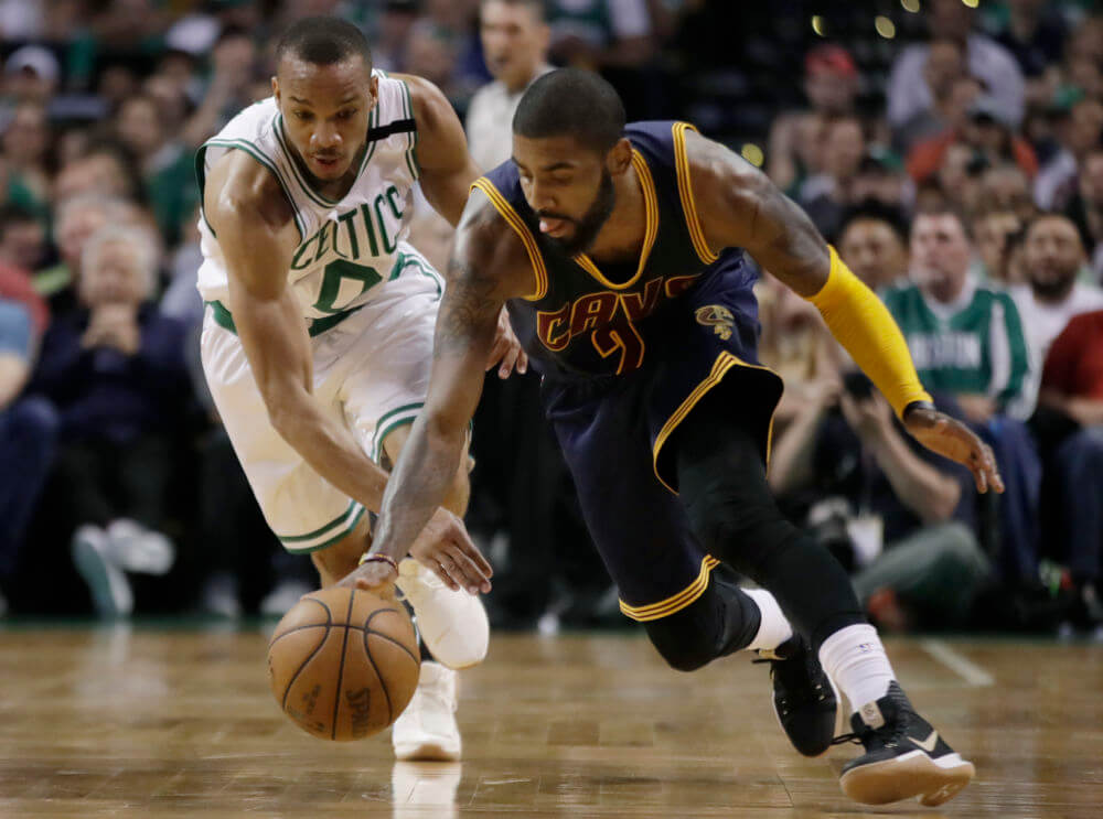 Cleveland Cavaliers guard Kyrie Irving dribbles away from Boston Celtics guard Avery Bradley during the first half of Game 2 of the NBA basketball Eastern Conference finals Friday