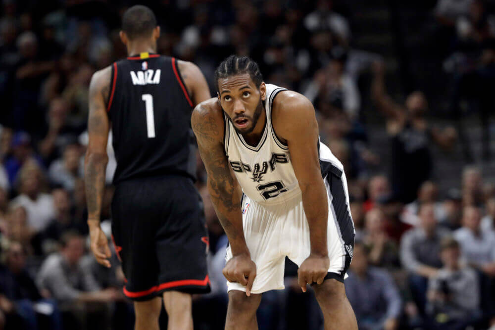 San Antonio Spurs&#039 Kawhi Leonard takes a breather as Houston Rockets&#039 Trevor Ariza walks down court during the second half of Game 2 in a second-round NBA basketball playoff series Wednesday