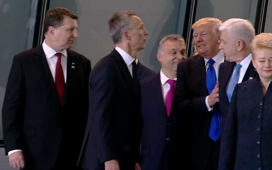 In this image taken from NATO TV Montenegro Prime Minister Dusko Markovic second right appears to be pushed by US President Donald Trump as they were given a tour of NATO's new headquarters after taking part in a group