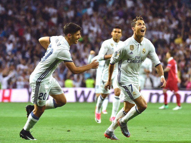 Real Madrid's Portuguese forward Cristiano Ronaldo celebrates with Real Madrid's midfielder Marco Asensio after scoring during the Spanish league football match Real Madrid CF vs Sevilla FC at the Santiago Bernabeu stadium in Madrid