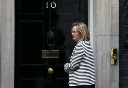 Britain's Home Secretary Amber Rudd waits for the door of 10 Downing Street to be opened for her in London