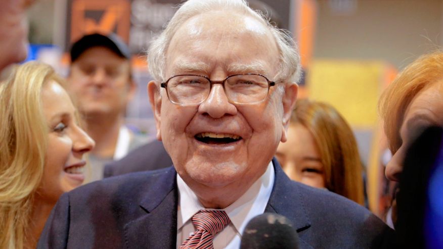 Berkshire Hathaway Chairman and CEO Warren Buffett laughs while touring the exhibit floor at the Century Link Center in Omaha Neb. Saturday