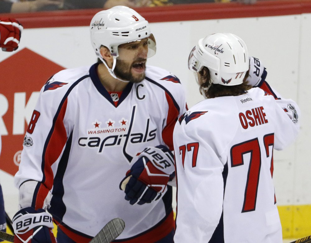 Washington's T.J. Oshie right celebrates his goal with Alex Ovechkin in the first period Monday against the Pittsburgh Penguins. The Capitals stayed alive with a 5-2 win