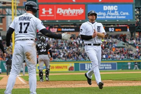 John Hicks is greeted by Andrew Romine after scoring