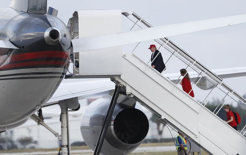 President-elect Donald Trump followed by his wife Melania Trump and son Barron Trump boards his plane at Palm Beach International Airport Sunday Nov. 27 2016