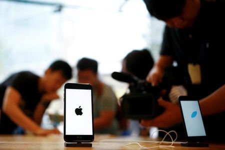 Members of the media film the new iPhone 7 at an Apple store in Beijing