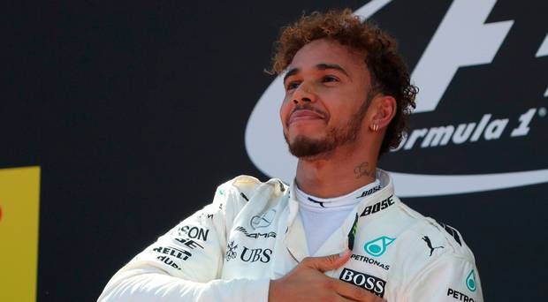 Mercedes driver Lewis Hamilton of Britain celebrates on the podium after winning the Spanish Formula One Grand Prix