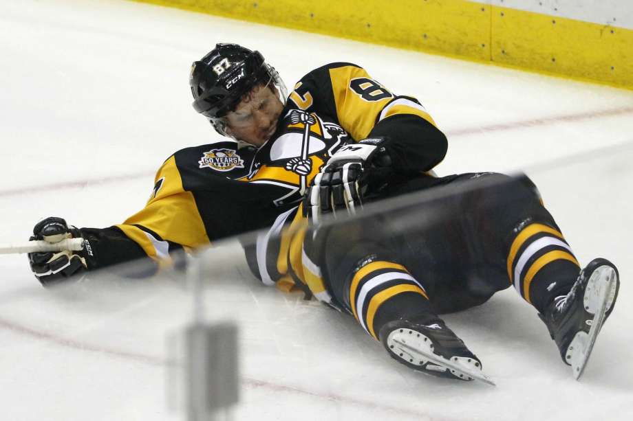 Pittsburgh Penguins Sidney Crosby lies on the ice after taking a hit from Washington Capitals Matt Niskanen during the first period of Game 3 in an NHL Stanley Cup Eastern Conference semifinal hockey game against the Washington Capitals in Pittsbur