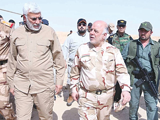 Mosul Iraqi Prime Minister Haider al Abadi walks with Abu Mahdi al Muhandis, the deputy commander of the Popular Mobilisation Forces during his visit to this city.—Reuters