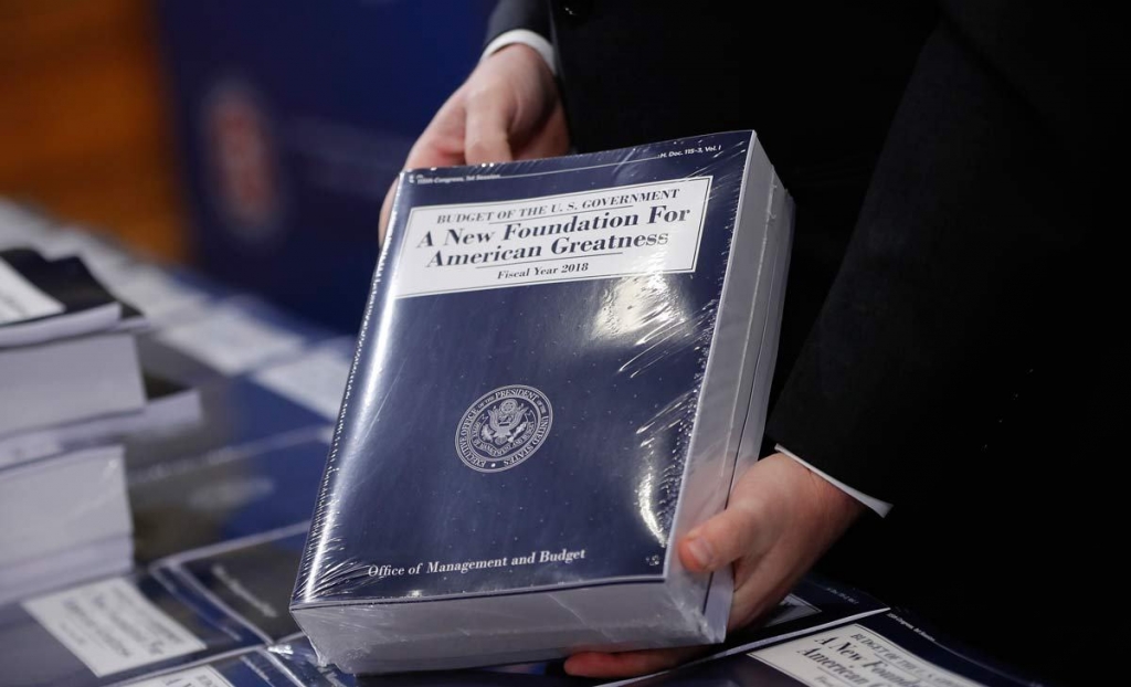 Eric Ueland Republican staff director Senate Budget Committee holds a copy of President Donald Trump's fiscal 2018 federal budget before distributing them to congressional staffers on Capitol Hill in Washington Tuesday