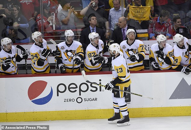 Pittsburgh Penguins center Nick Bonino celebrates his goal with Sidney Crosby and others during the third period of Game 1 in an NHL hockey Stanley Cup second-round playoff series against the Washington Capitals Thursday