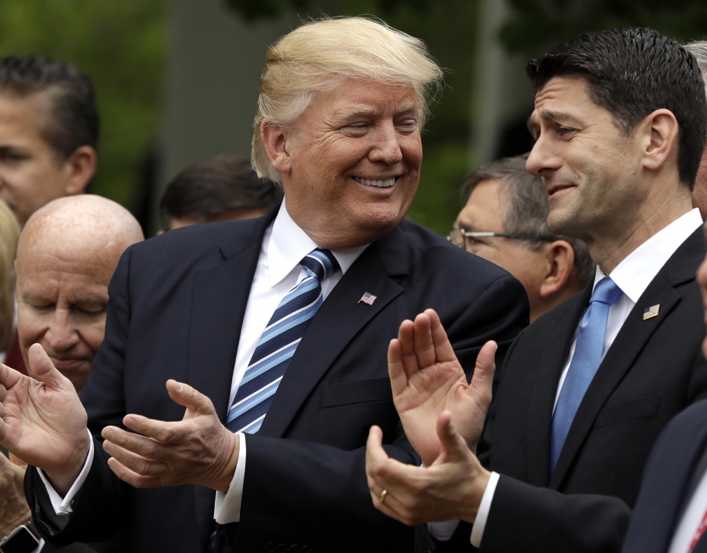 President Donald Trump talks to House Speaker Paul Ryan of Wisconsin in the Rose Garden of the White House in Washington after the House pushed through a health care bill