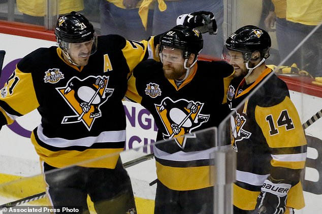 Pittsburgh Penguins Phil Kessel center celebrates with teammates Evgeni Malkin and Chris Kunitz after scoring against the Ottawa Senators during the third period of Game 2 of the Eastern Conference final in the NHL hockey Stanley Cup playoffs