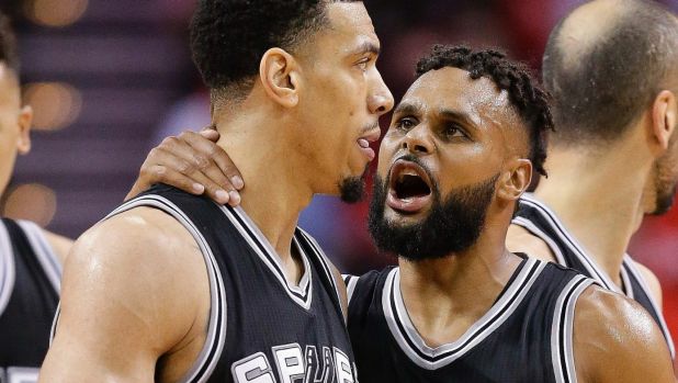 Patty Mills talks with guard Danny Green as Spurs ousted the Rockets from the NBA conference semi-finals