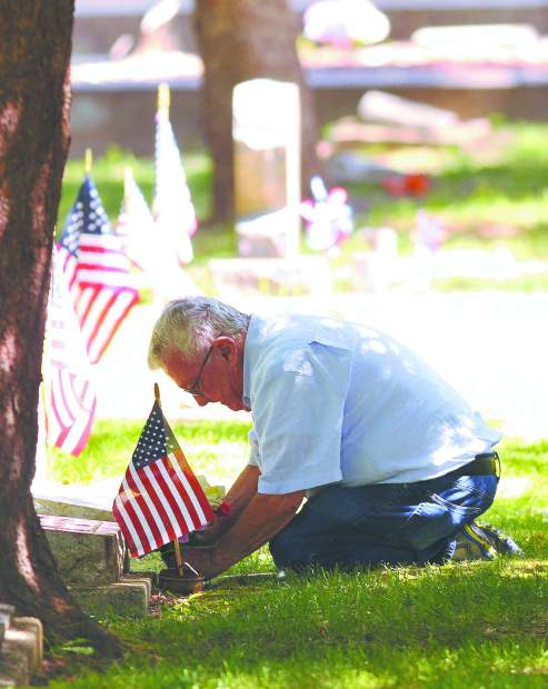 Volunteers place flags at graves of veterans in Buffalo Gap